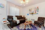 Spacious living area with a cushioned sofa/accent chair -converts into sofa bed-